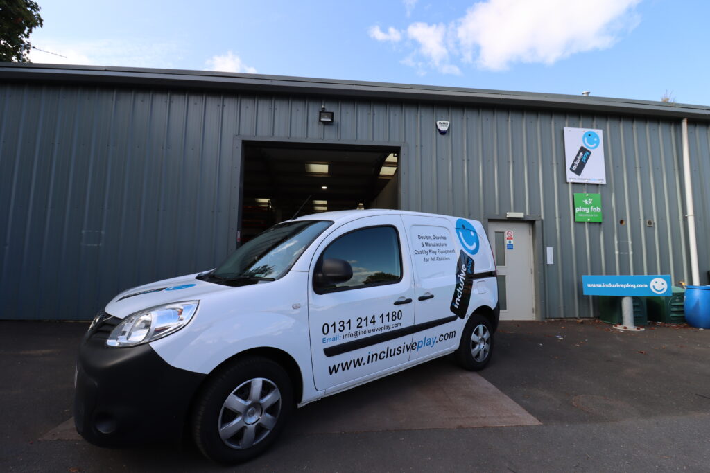 White Inclusive Play branded delivery van parked outside the Inclusive Play manufacturing and supply facility in Loanhead, Edinburgh.